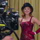 Elizabeth Olsen filming a scene from WandaVision in which Wanda is portraying a magician's stage assistant.